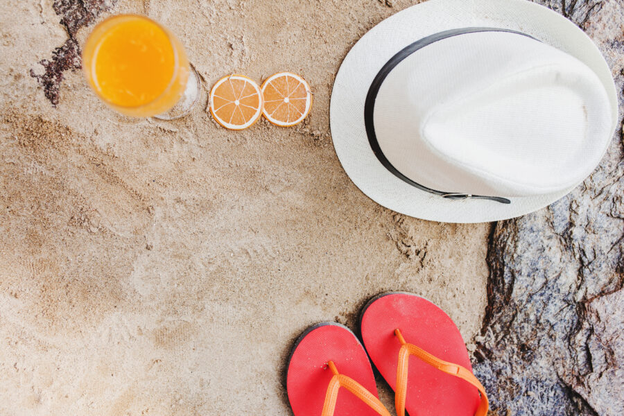 top view orange juice flip flops hat